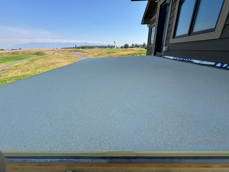 Finished textured waterproof walk-deck surface overlooking mountains.