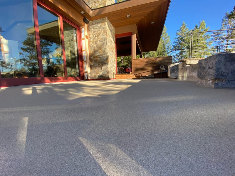 Finished sand-broadcast waterproofing surface over a concrete deck on a Lakeside home.