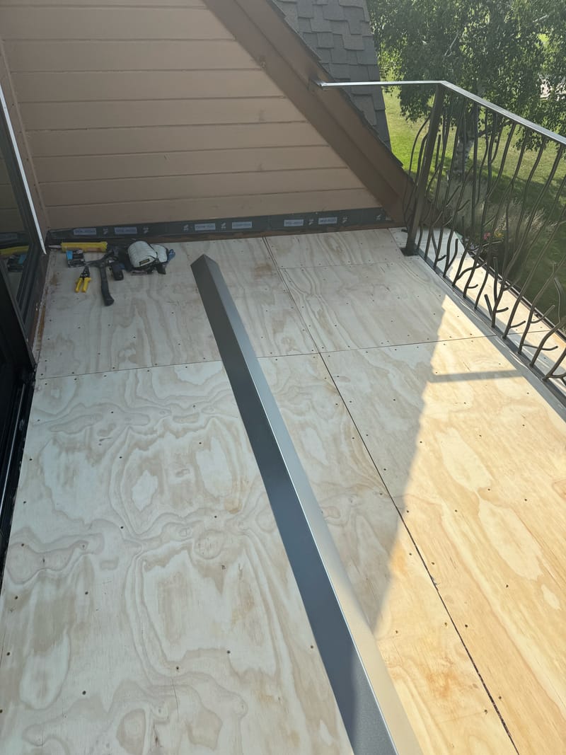 New plywood balcony substrate with metal edge and drip flashing.