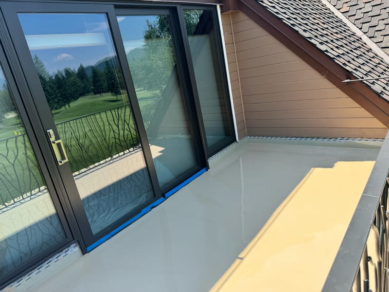Wet base waterproofing membrane over the prepared balcony, golf course beyond.